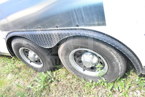 2020 LGS TX 8.5'x24' food trailer tires and metal fender. Grass background.