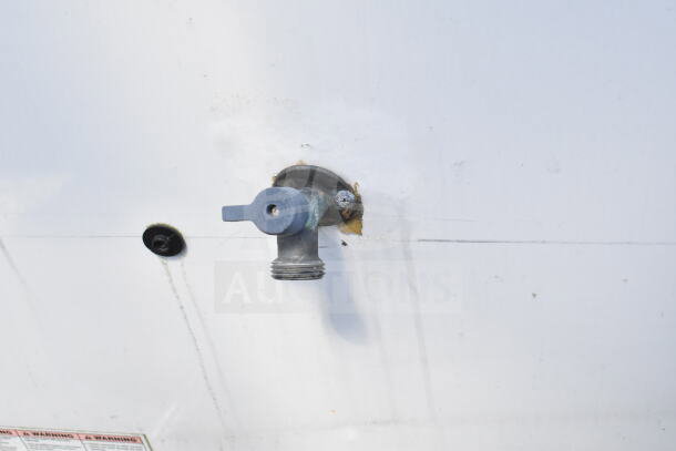 Exterior faucet on 2020 LGS TX 8.5'x24' food trailer, attached to white surface.