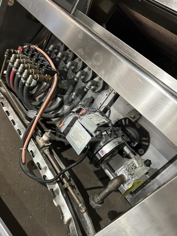 Empire Model LFM-5-80X100 bakery deck oven internals showing gas connections and digital controls. Stainless steel construction.