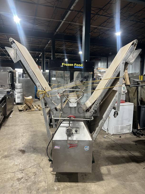 Moline heavy-duty reversible conveyorized dough sheeter with foot pedal, stainless steel, commercial use, good condition.