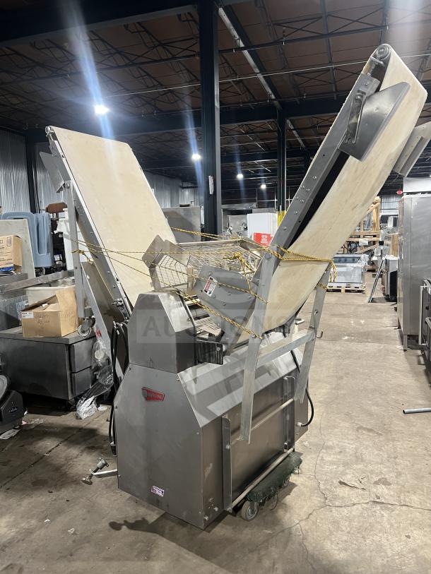 Moline heavy-duty commercial reversible dough sheeter, conveyorized, with foot pedal. Good condition, visible brand logo.