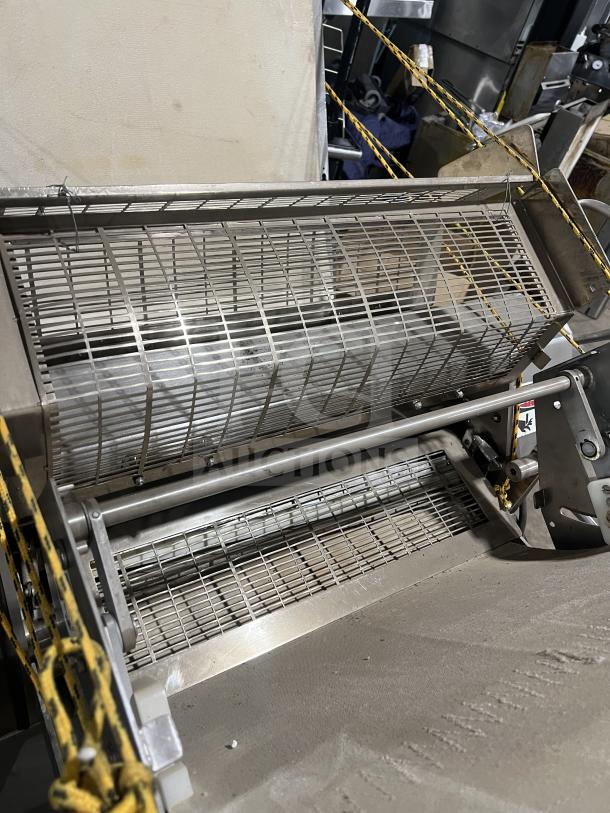 Moline heavy-duty reversible conveyorized dough sheeter with foot pedal, floor style, in good condition.