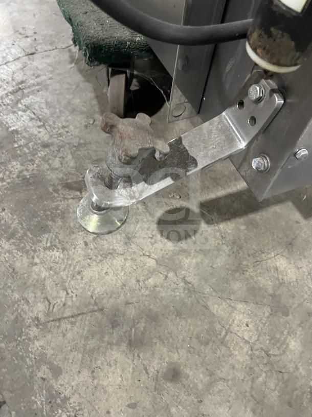 Moline reversible conveyorized dough sheeter in used condition with foot pedal visible, designed for heavy-duty commercial use.