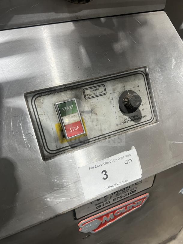 Moline heavy-duty commercial dough sheeter with foot pedal and control panel. Features start/stop buttons and settings dial.