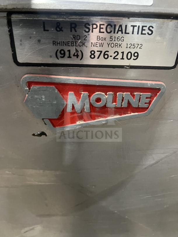 Moline heavy-duty commercial dough sheeter with foot pedal, showing brand label and contact information tag.