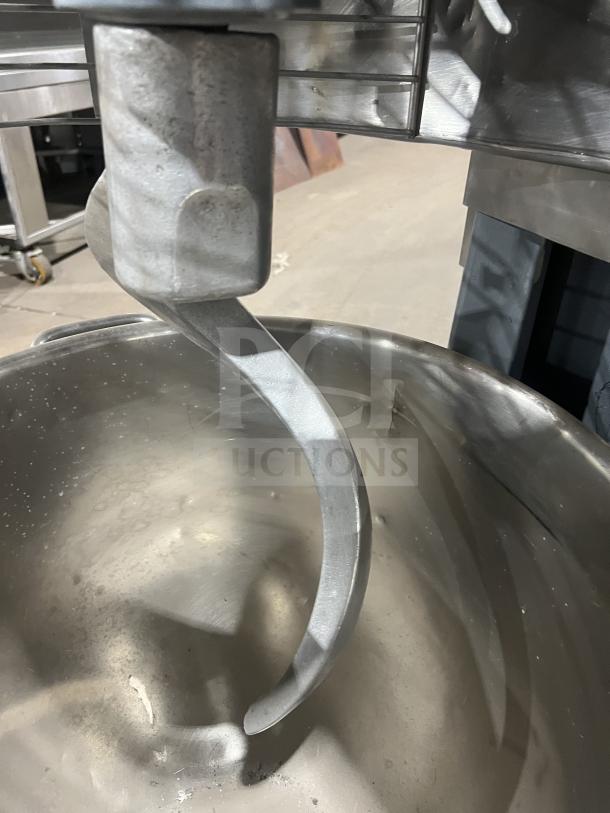 Hobart HL661 commercial mixer with stainless steel bowl and dough hook. Features bowl guard. Electric powered, on legs.