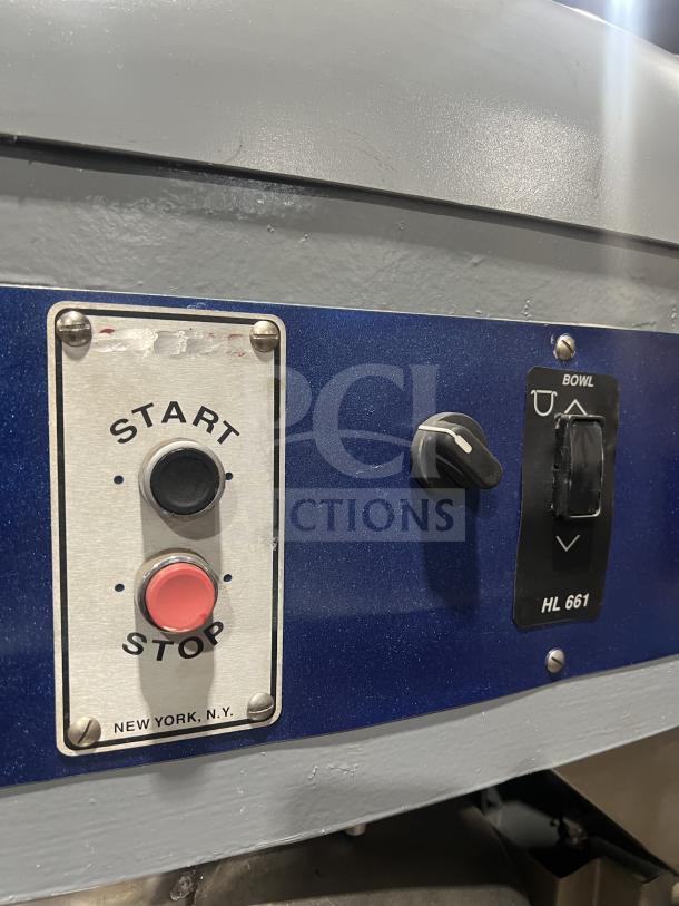 Hobart HL661 commercial blue bench mixer, electric powered, with stainless steel bowl guard, start/stop buttons, on legs.