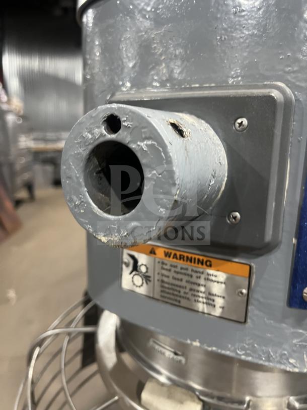 Hobart model HL661 blue electric bench planetary mixer with stainless steel bowl guard, warning label visible.