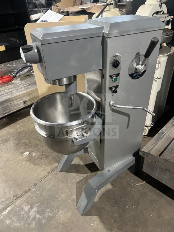 Univex floor-style planetary mixer with stainless steel mixing bowl, mounted on legs, featuring control dials and handle.