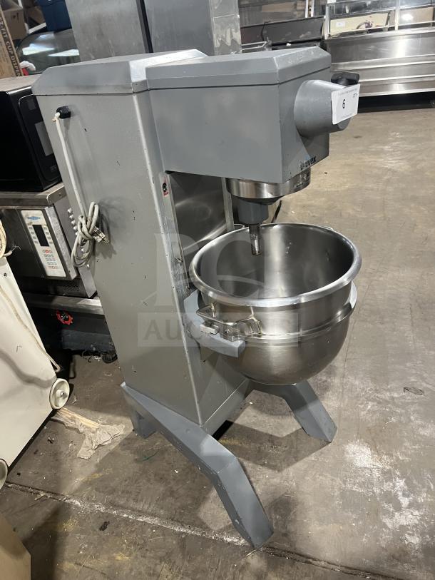 Univex floor-style planetary mixer with stainless steel mixing bowl. In good condition, mounted on sturdy legs.