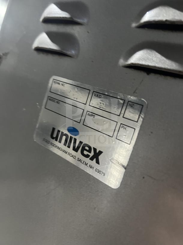 Univex floor-style planetary mixer with stainless steel mixing bowl and legs. Features manufacturer's label.
