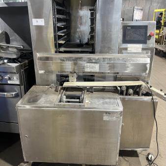 Commercial stainless steel Moline Machinery bakery production table with automated dough cutting system on casters.