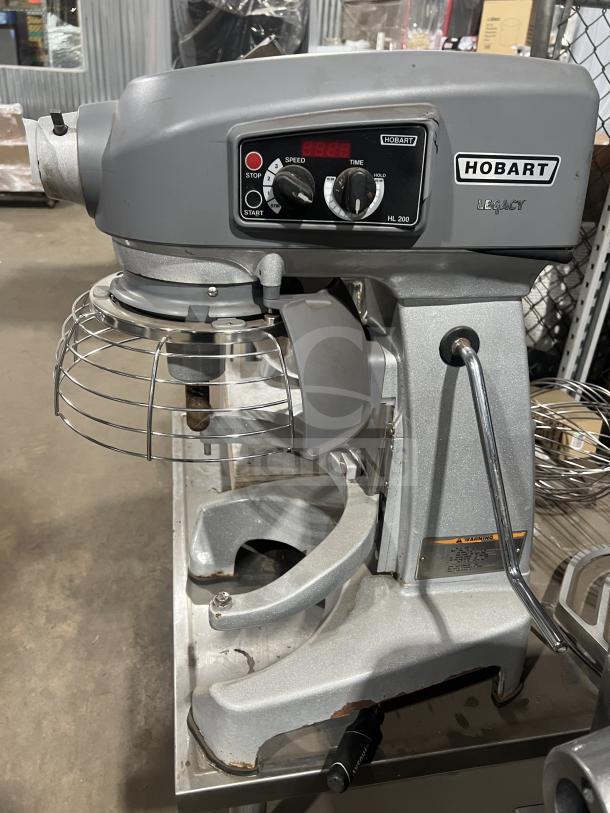 Hobart commercial countertop planetary mixer, multi-speed, model HL 200, 100-120V, with bowl lift, visible wear on base.