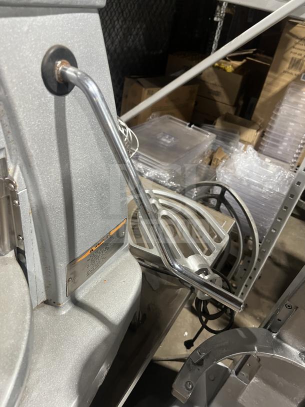 Hobart commercial planetary mixer with bowl lift, multi-speed, 100-120V, 1 phase. Visible controls, warning label, and metallic finish.