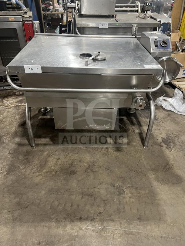 Commercial stainless steel braising pan with tilting skillet feature, mounted on legs. Clean condition, includes dial and handle.