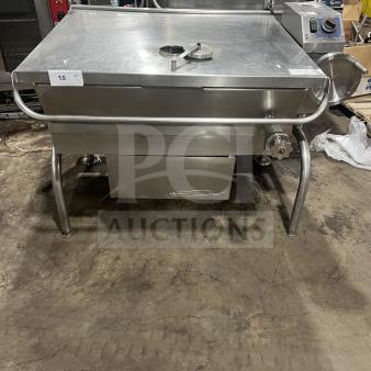 Commercial stainless steel braising pan with tilting skillet feature, mounted on legs. Clean condition, includes dial and handle.