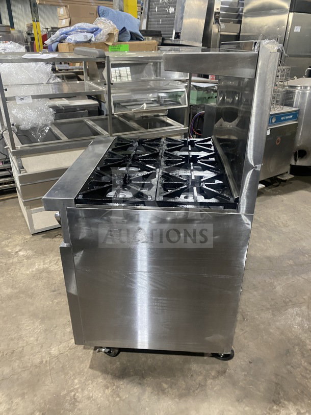 CookRite 6-burner gas range/oven combo in stainless steel, with backsplash, salamander shelf, wired oven rack, on casters.