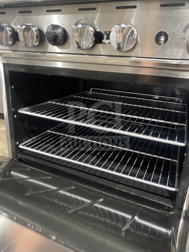 CookRite commercial stainless steel 6-burner gas range with oven, backsplash, overhead salamander shelf, and wired oven rack.