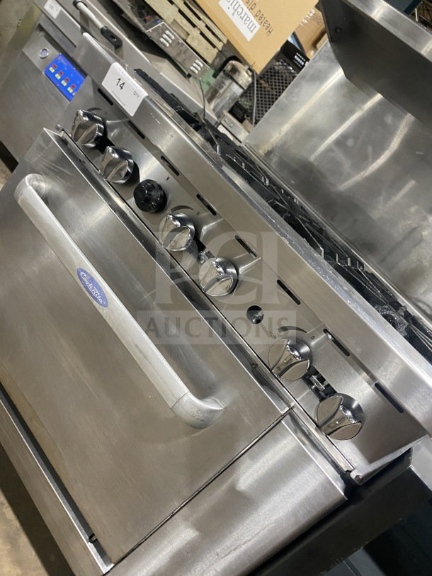 CookRite commercial stainless steel 6-burner range/oven combo with back splash, salamander shelf, and wired oven rack on casters.