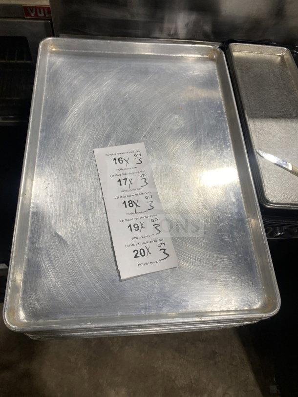 Commercial stainless steel baking sheet pan in good condition, features auction labels indicating multiple quantities available.