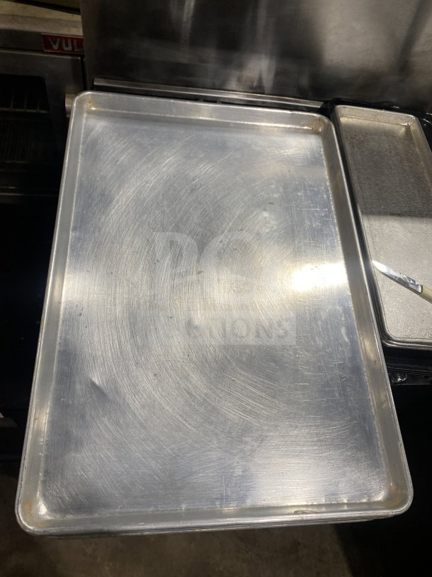 Commercial stainless steel baking sheet pan, lightly used, durable construction, ideal for professional baking.