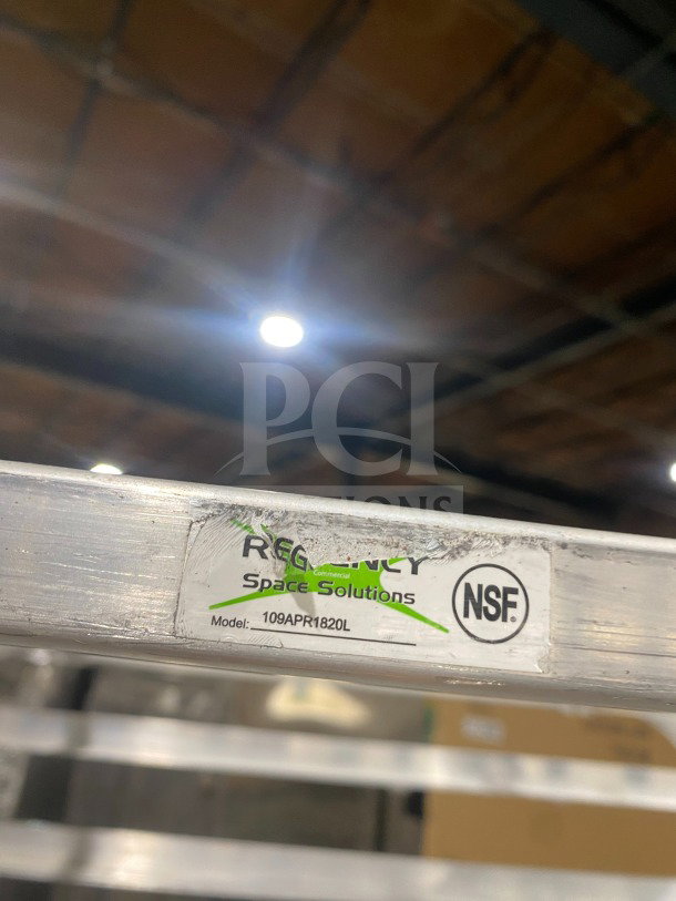 Regency stainless steel pan rack, model 109APR1820L, on casters, with visible label and NSF mark, in good condition.