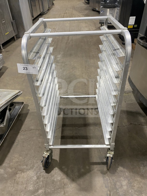 Commercial stainless steel heavy-duty 10-pan rack on casters, welded construction, good condition, item tag visible.