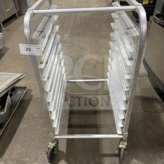 Commercial stainless steel heavy-duty 10-pan rack on casters, welded construction, good condition, item tag visible.