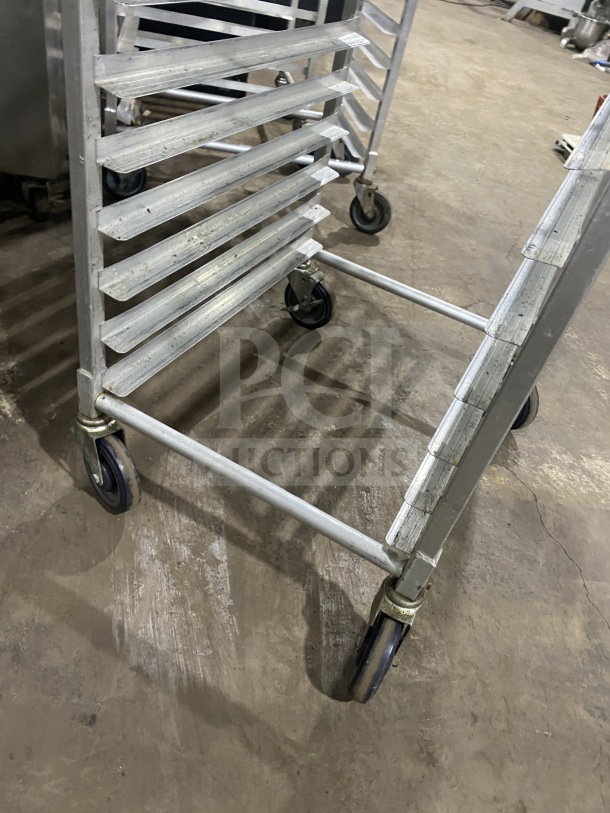 Commercial stainless steel 10-pan sheet rack with casters. Heavy-duty welded construction. Good condition.