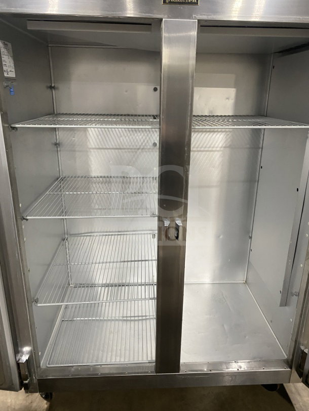 Traulsen G22010 stainless steel 2-door reach-in refrigerator, poly-coated wire racks, model SN: T987554JO8, on casters.