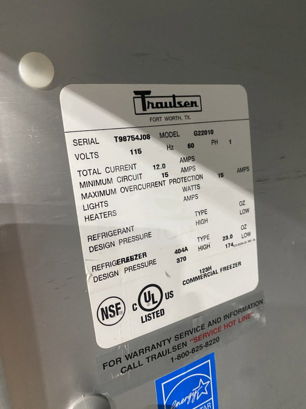 Traulsen G22010 commercial stainless steel 2-door refrigerator, poly-coated racks, 115V, 1 phase, on casters, model tag visible.
