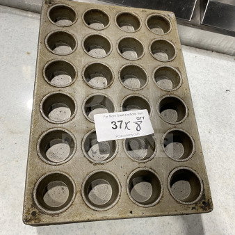 Commercial stainless steel 24-cup muffin pan, used, visible wear, auction tag: "37X 8."