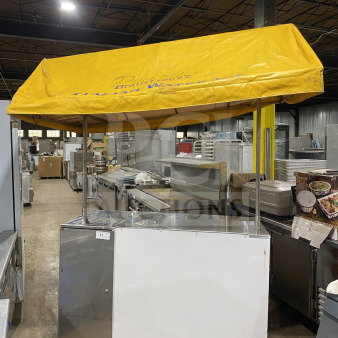 Rare commercial food vending cart with yellow overhead canopy, curved glass-top display bunker freezer, on wheels and casters.