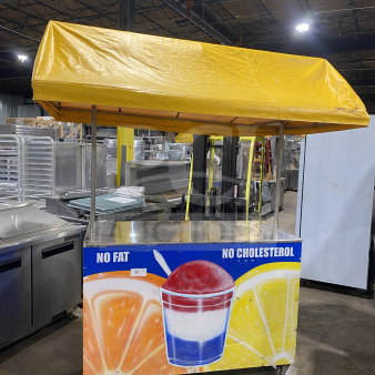 Rare commercial food vending cart with overhead yellow canopy, curved glass-top display bunker freezer, on casters, colorful graphics.
