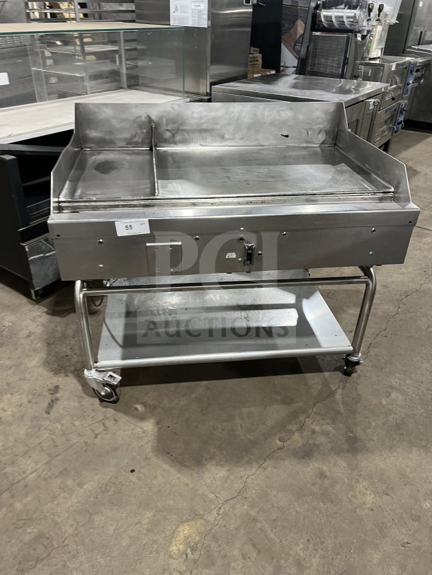 Commercial stainless steel heavy-duty griddle, dual sections, with back and side splash, on casters, good condition.