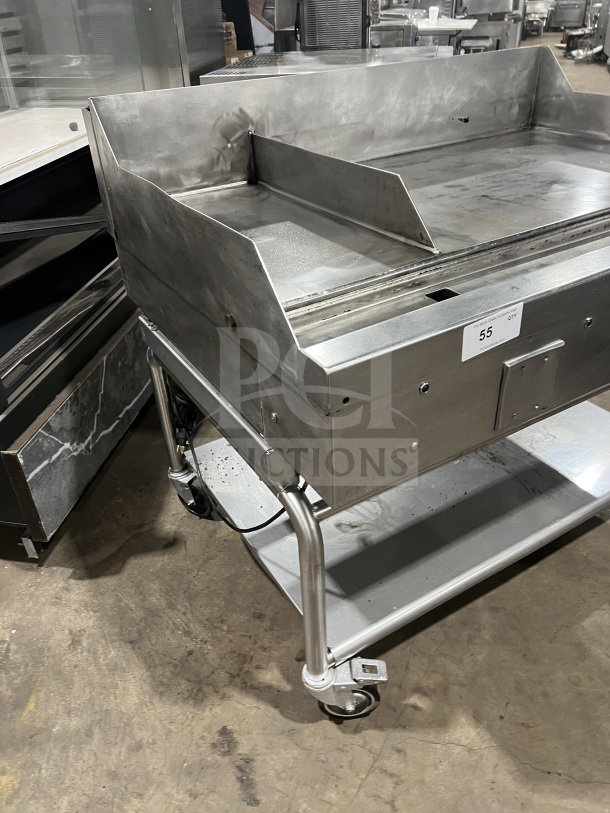 Commercial stainless steel heavy-duty griddle with two sections, flat-top, back and side splash, on casters.