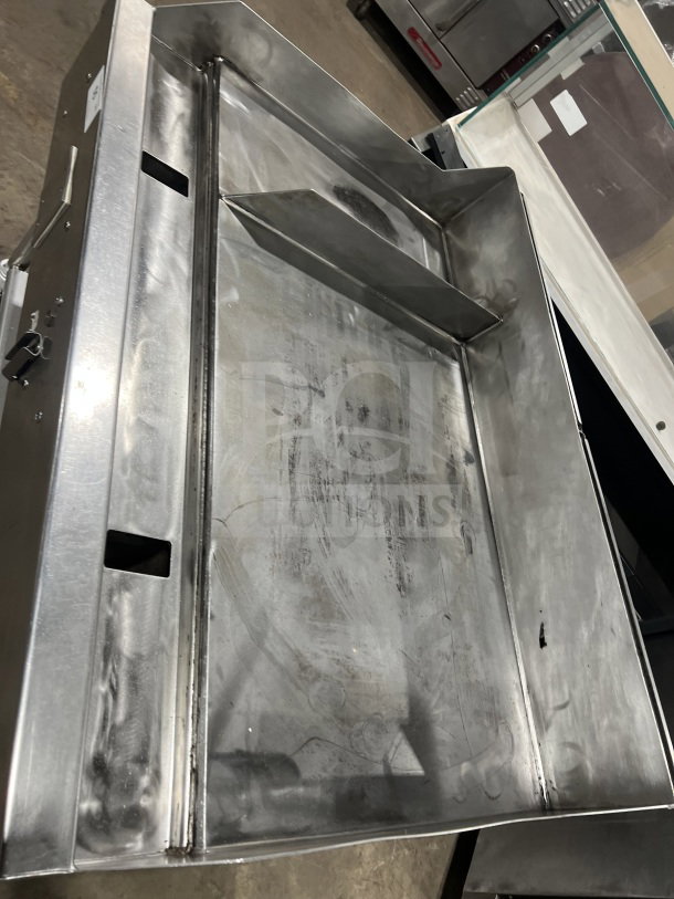 Commercial stainless steel heavy-duty flat-top griddle with two sections, back and side splash, and casters.