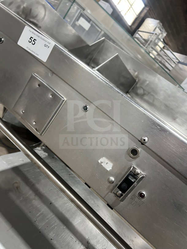 Commercial stainless steel heavy-duty flat-top griddle with back and side splash. Two sections, on casters, very good condition.