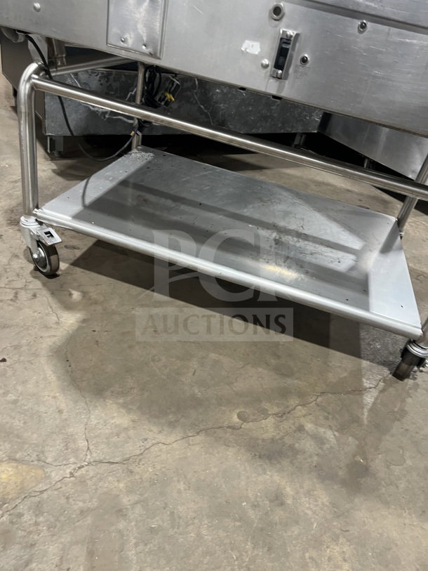 Commercial stainless steel flat-top griddle with back and side splash, two sections, on casters, heavy-duty design.