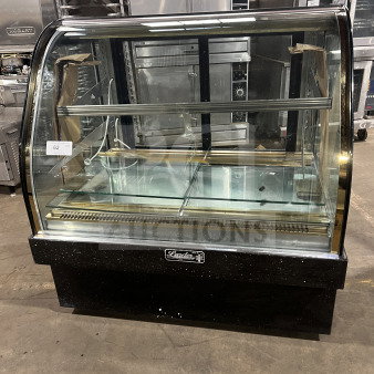 Leader commercial stainless steel bakery display case with curved glass, three tiers, and rear sliding doors.