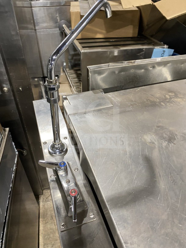 Market Forge commercial stainless steel tilting skillet braising pan with single spout faucet on legs; visible controls.