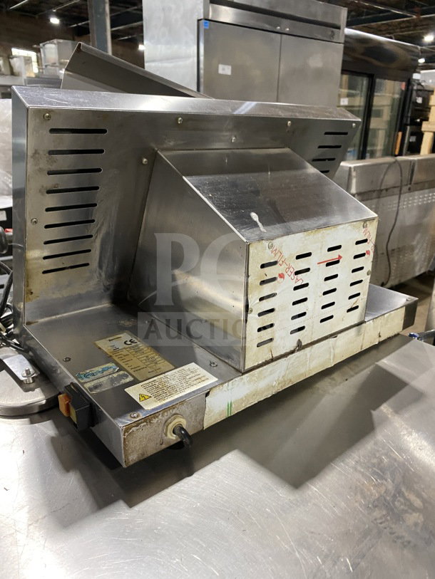 Omcan M42A commercial stainless steel food packaging machine, electric-powered, heavy-duty, visible labels, used condition.