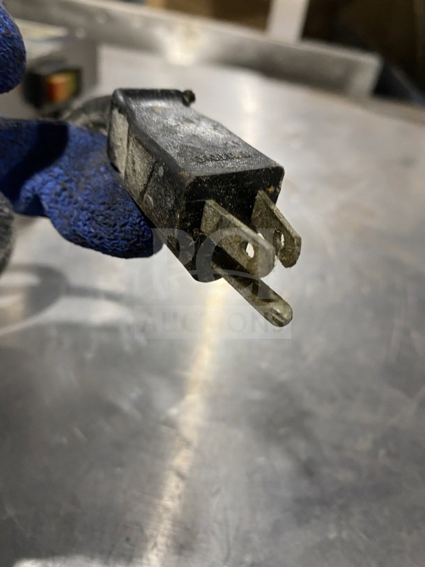 Omcan M42A commercial stainless steel food packaging machine plug, showing standard 110V connection.