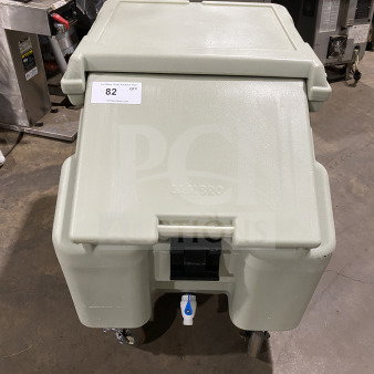 Cambro commercial insulated ice bin on wheels, beige, good condition, visible tap for drainage, auction tag 82.