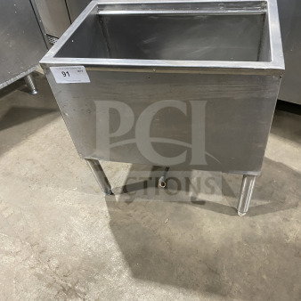 Stainless steel commercial underbar ice bin, insulated, on legs, used condition, auction tag "91" visible.
