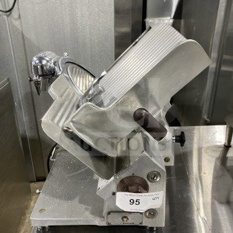 Commercial stainless steel heavy-duty gravity-feed meat slicer, model 685, SN: 694933, on legs, good condition.