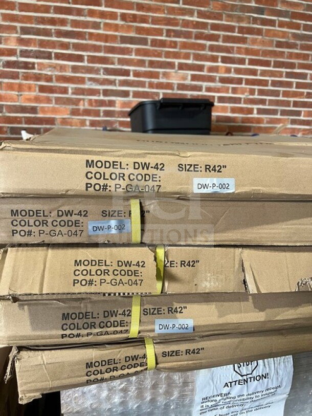 Brand new OCS DW42 42" round composite dining table in packaging, barn wood plank design, polished base, model details visible.