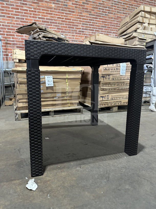 Brand new Rainbow Arizona Masa rattan table, dark brown, heavy-duty polypropylene, 80x80 cm, in warehouse setting.