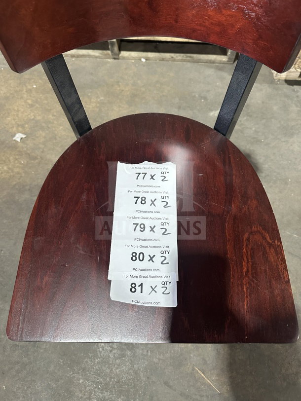 Brand new commercial restaurant chair with mahogany wood back and seat, veneer finish, and metal frame. Tags indicate auction details.