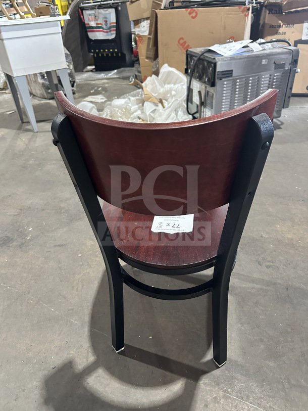 Brand new commercial restaurant chair with mahogany wood veneer back and seat, metal frame. Tags indicate quantity: 2X.